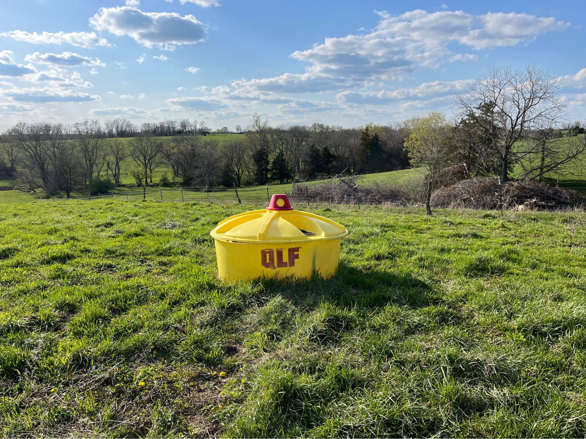 QLF liquid cattle lick feeder 250 gallons with 4 wheels. Machine Bluebook